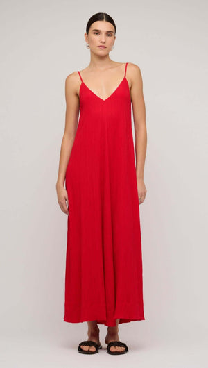 Model wearing a red crepe V-neck floaty maxi dress, showcasing a relaxed fit and summer style.