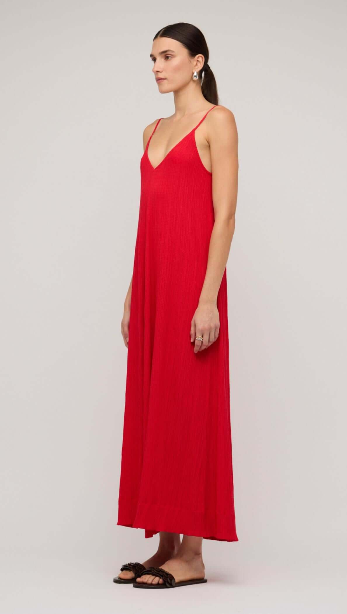 Model wearing a red crepe V-neck floaty maxi dress, showcasing a relaxed fit and elegant silhouette.