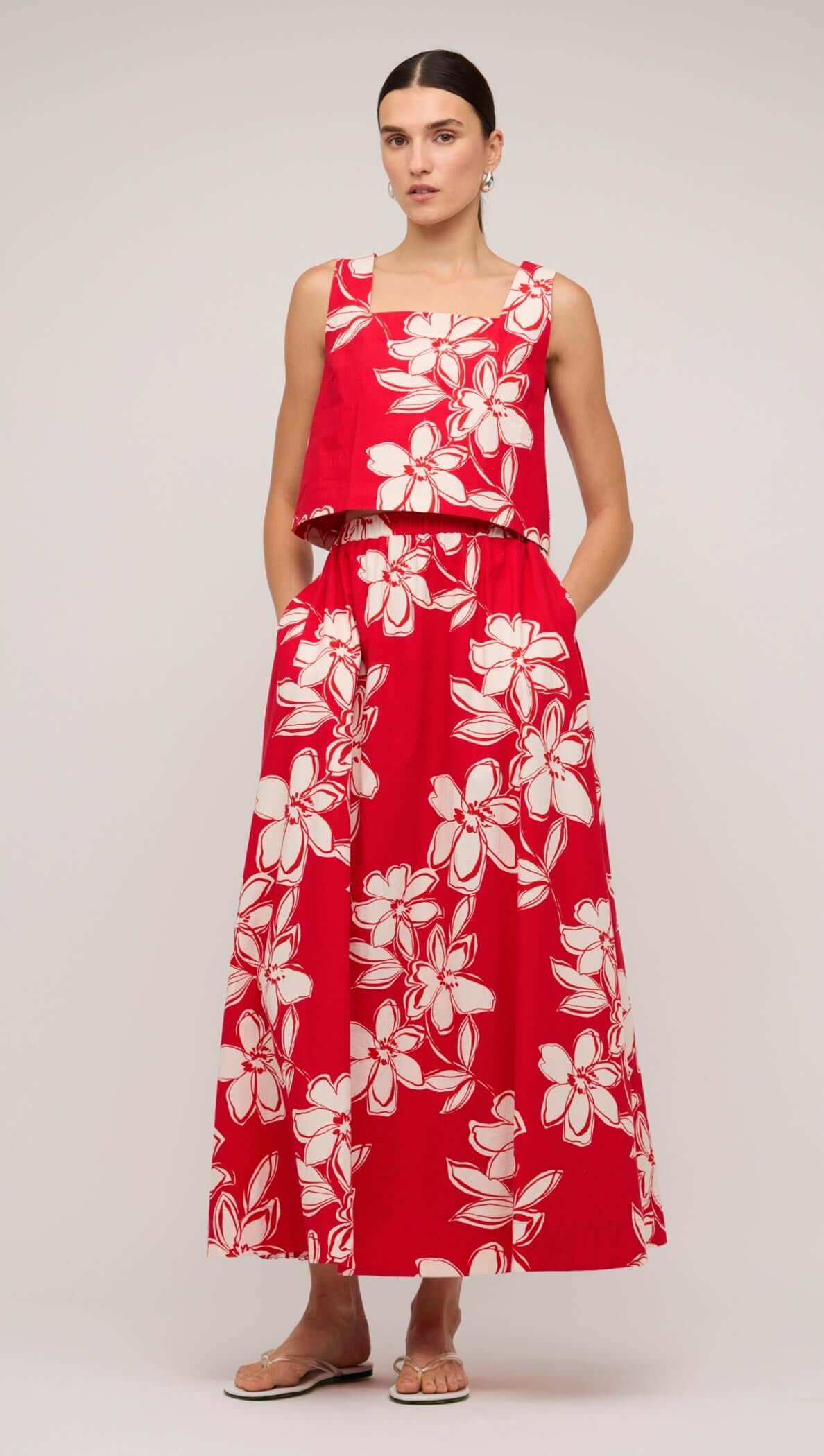 Model wearing a red and white floral cotton crop top paired with a matching long skirt, showcasing a stylish summer outfit.