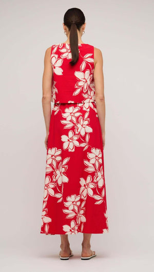 Back view of a woman wearing a red and white floral cotton crop top, showcasing a stylish and breezy summer look.