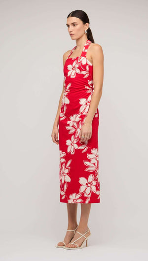 Red and white floral halter-neck midi dress on model, perfect for summer occasions and casual outings.