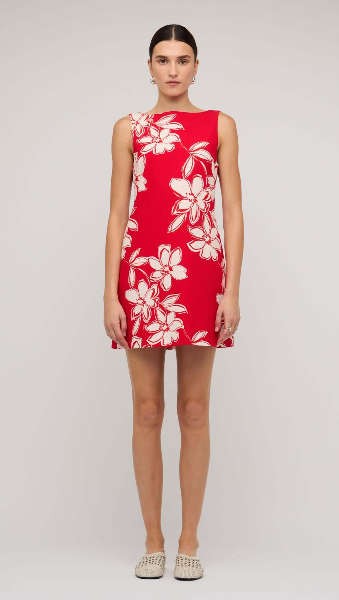 Model wearing a red and white floral mini shift dress, showcasing a bright and stylish summer look.