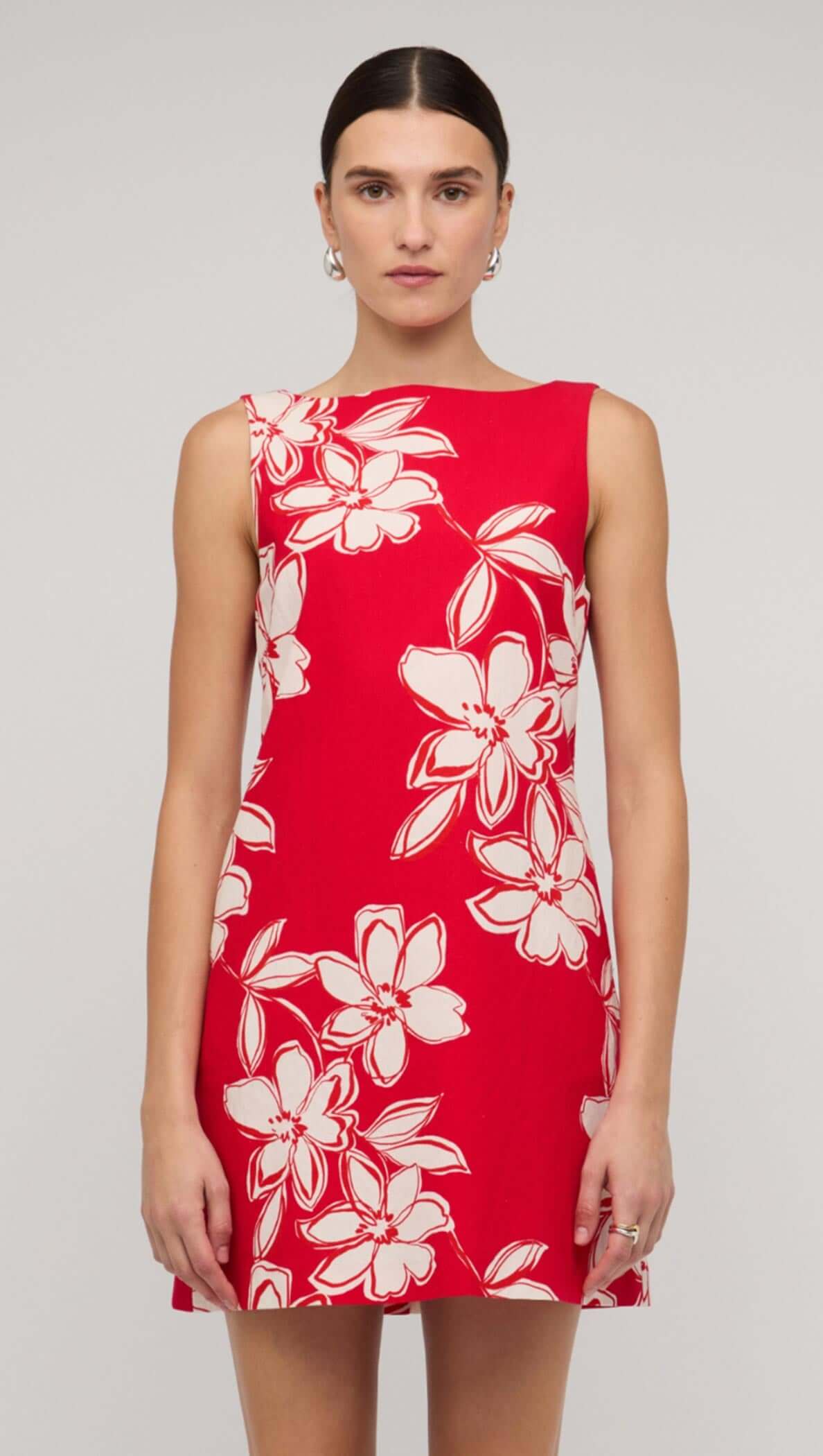 Model wearing a red and white floral mini shift dress, showcasing a vibrant design perfect for summer outings.