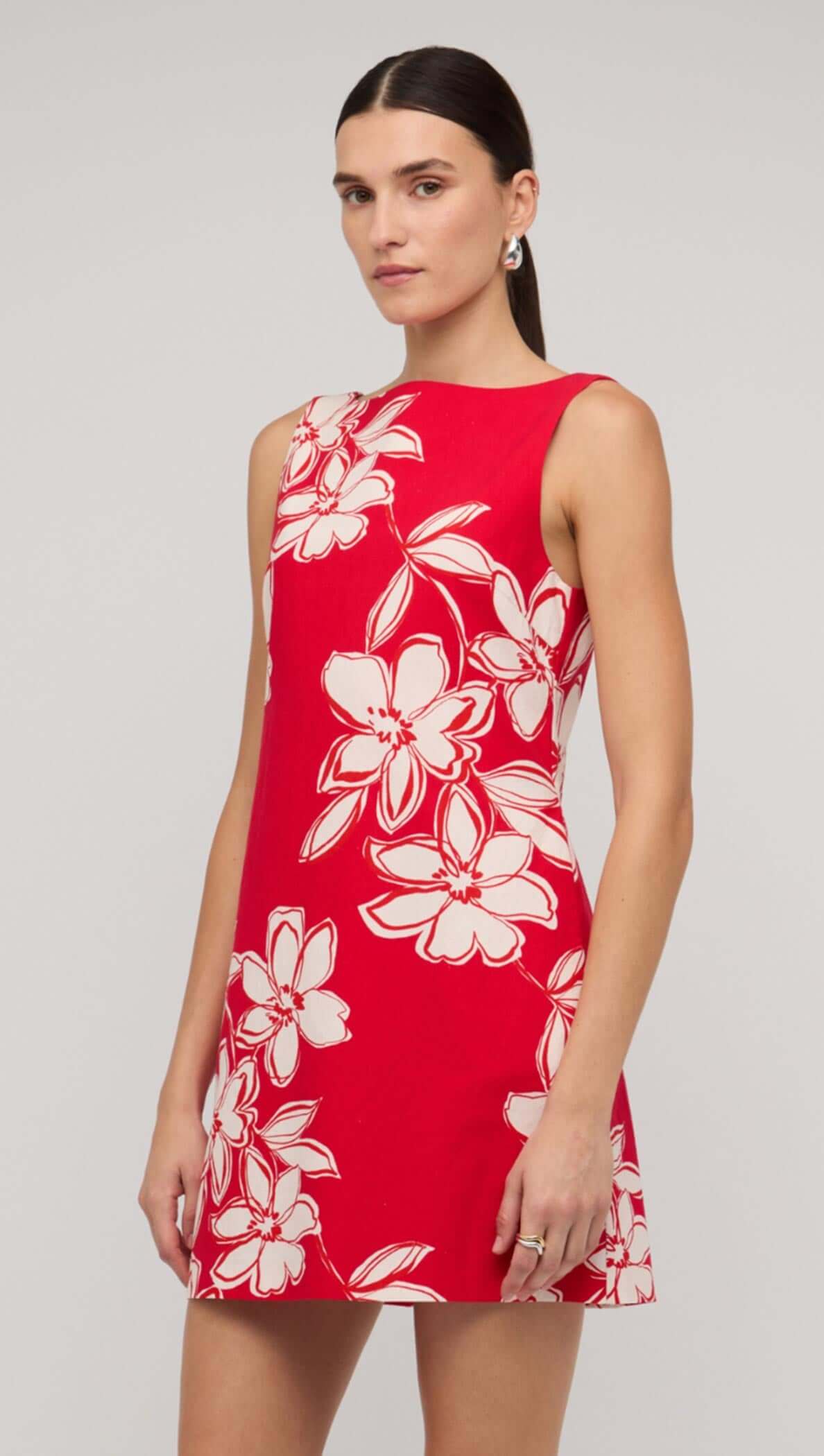 Red and white floral mini shift dress on model, showcasing a vibrant design perfect for summer fashion.