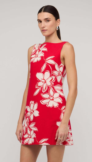Red and white floral mini shift dress on model, showcasing a vibrant design perfect for summer fashion.