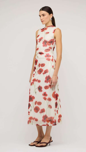 Model wearing a red and white poppy print mesh midi dress, showcasing a floral pattern with a chic design.