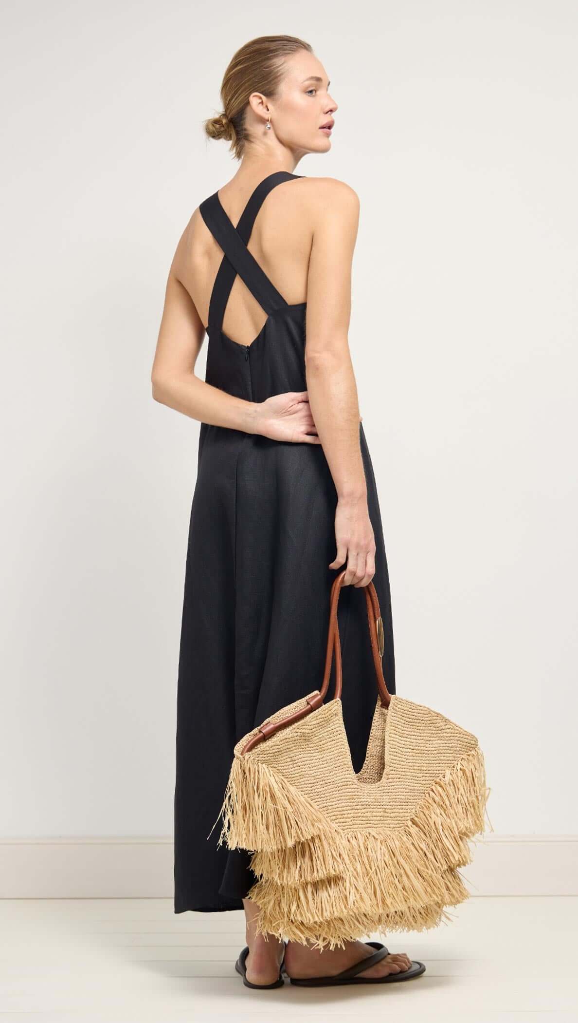 Black Cross Back V-Neck Maxi Dress on model, showcasing deep V-neckline and cross-back straps.
