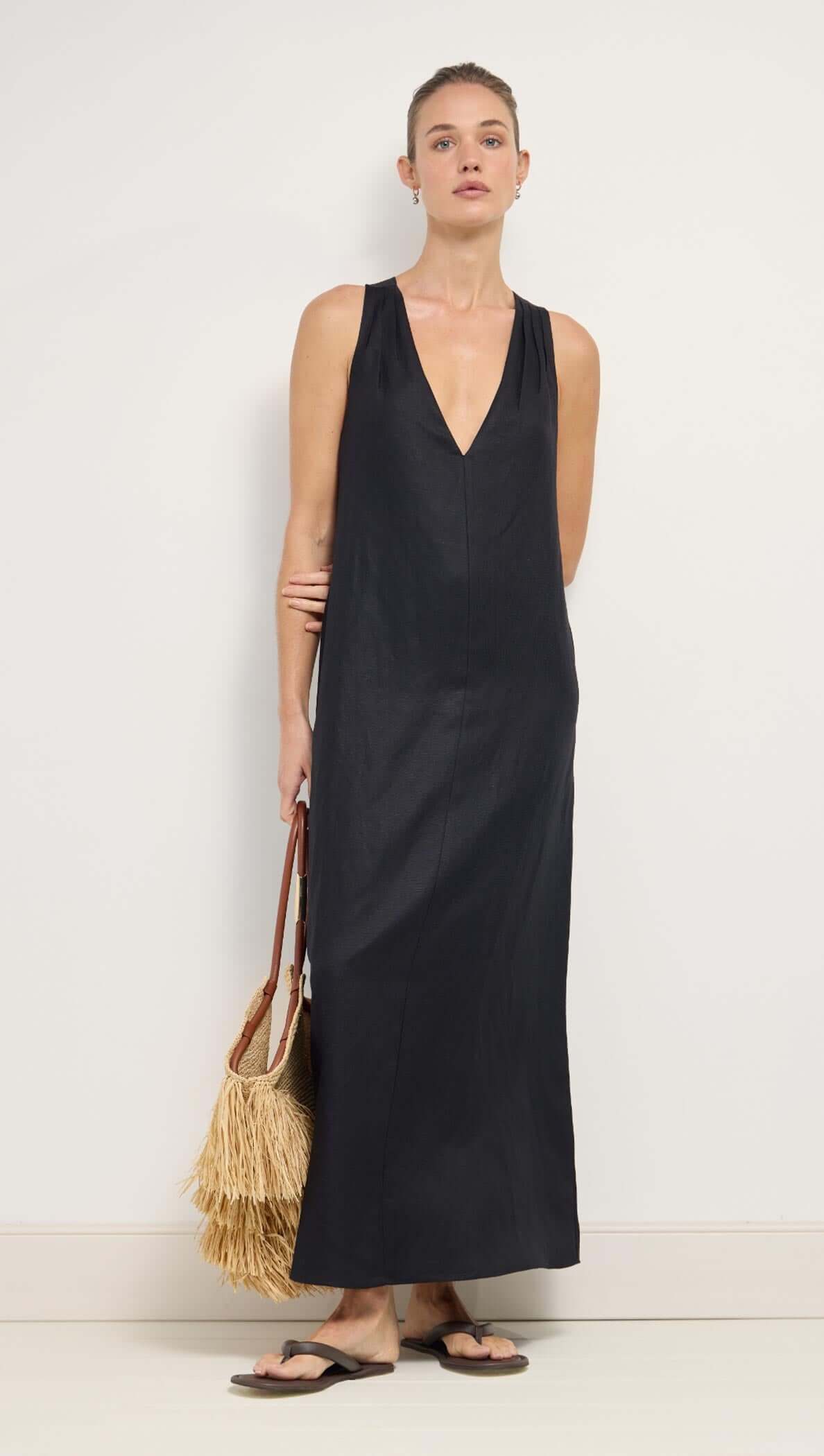 Black Cross Back V-Neck Maxi Dress on model, showcasing deep V-neckline and cross-back straps.