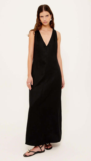 Black Cross Back V-Neck Maxi Dress worn by a model showcasing its elegant silhouette and deep V-neckline.