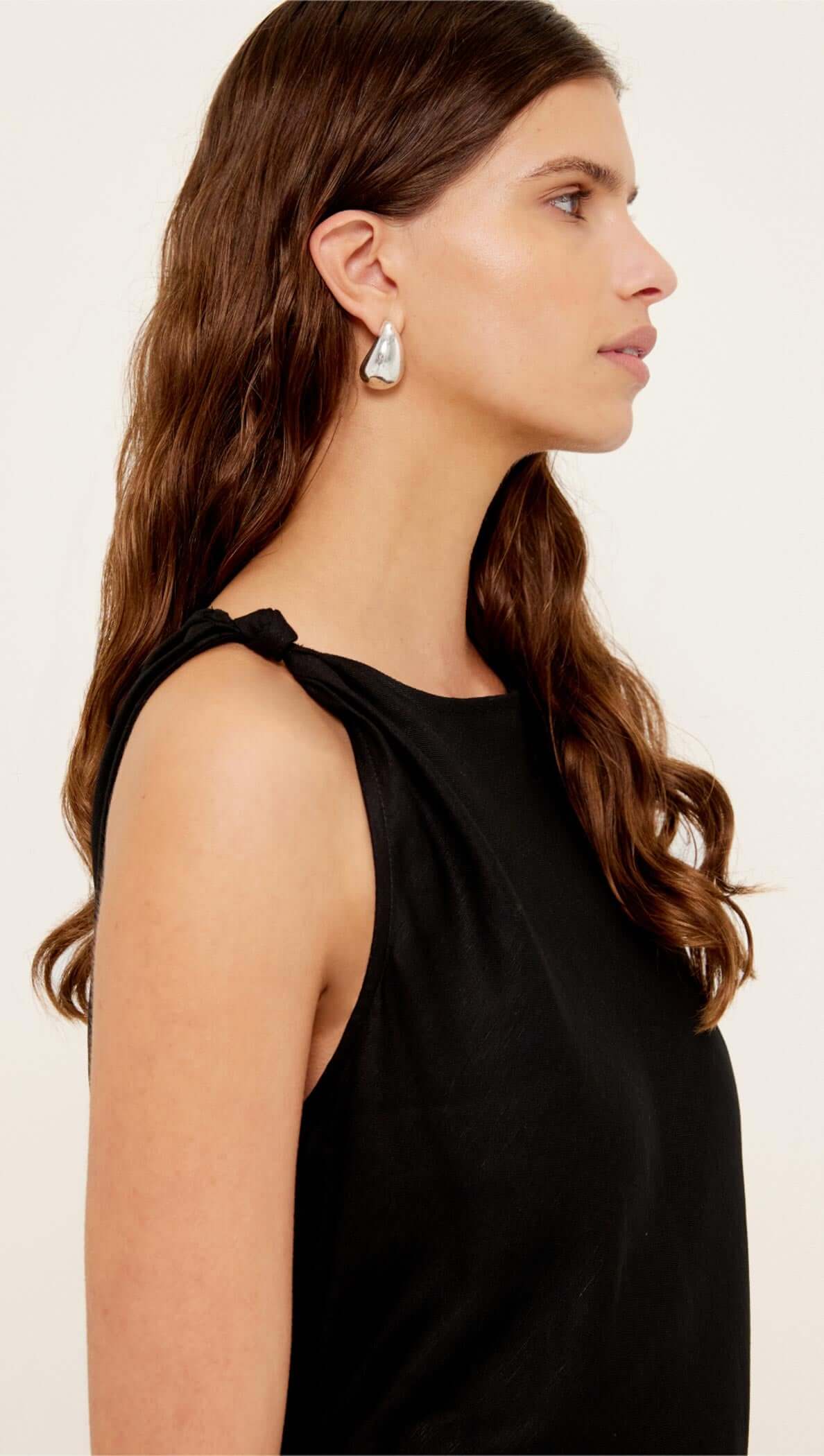 Linen Blend Black Midi Dress with Tie Waist showcasing a side view of the dress and the model's hairstyle.