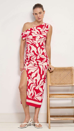 Cotton Blend Red & White Floral Asymmetrical Midi Dress displayed on a model with a wooden chair in the background.