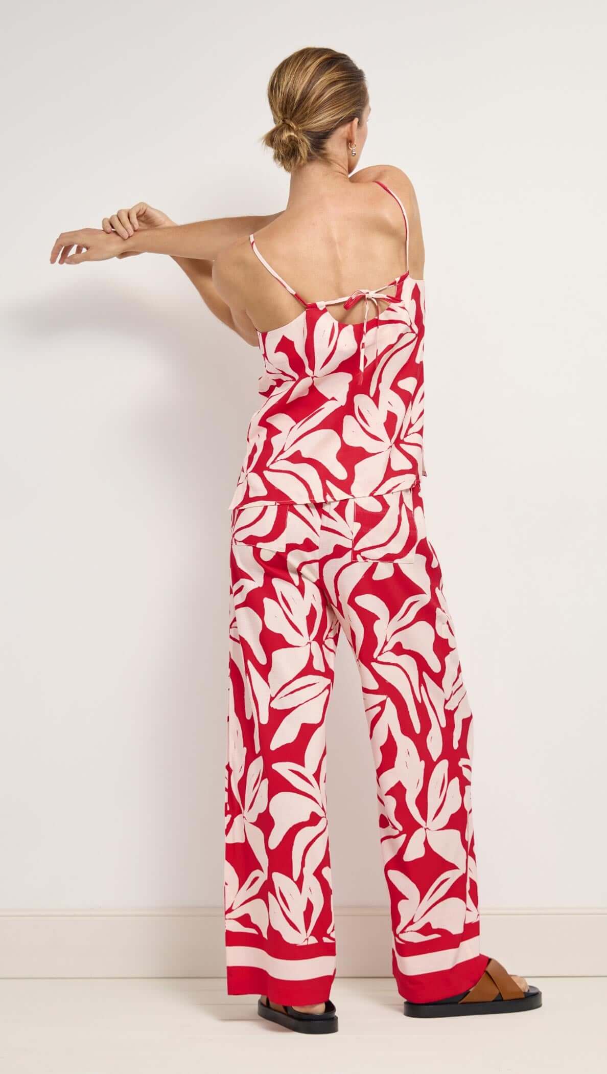 Cotton Blend Red & White Floral Print Drawstring Pants worn by a model, showcasing a relaxed back view with floral design.