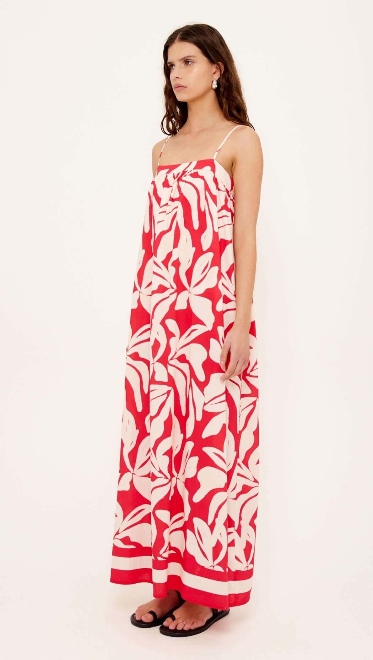 Cotton Blend Red & White Floral Print Maxi Dress worn by a model, showcasing the flowy design and vibrant floral pattern.
