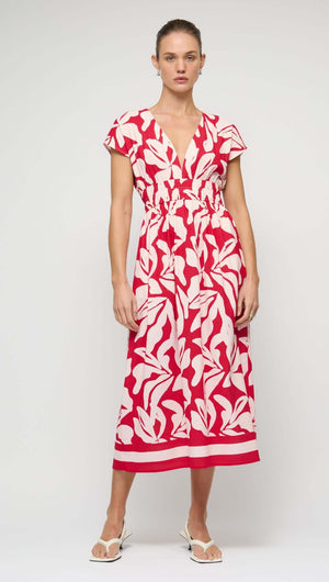 Cotton Blend Red & White Floral Print Shirred Midi Dress on a model, featuring a deep V neckline and shirred waist.