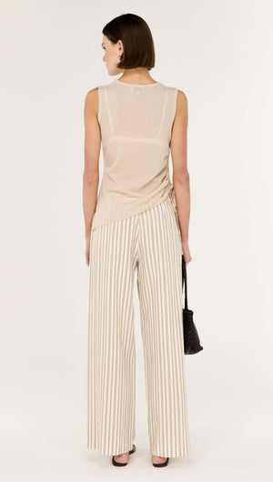 Back view of a model wearing a Sheer Drawstring Knit Tank Top paired with striped wide-leg pants.