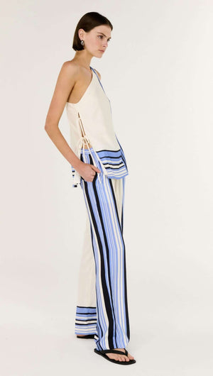 Model wearing the Stripe One Shoulder Top paired with striped pants, showcasing a chic and modern look.