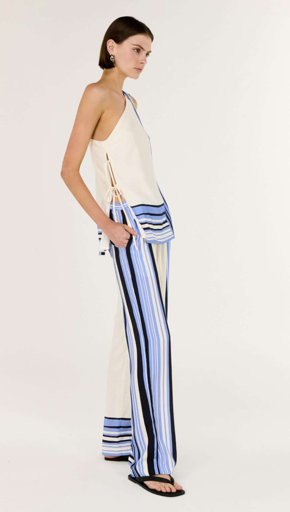 Model wearing Stripe Relaxed Wide-Leg Low Rise Pants with spliced stripes and a chic top.