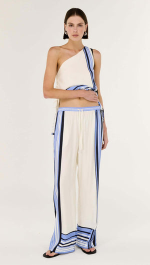 Model wearing Stripe Relaxed Wide-Leg Low Rise Pants featuring statement spliced stripe detailing and luxe viscose blend.