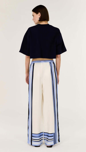 Back view of a model wearing Stripe Relaxed Wide-Leg Low Rise Pants with spliced stripe detailing.