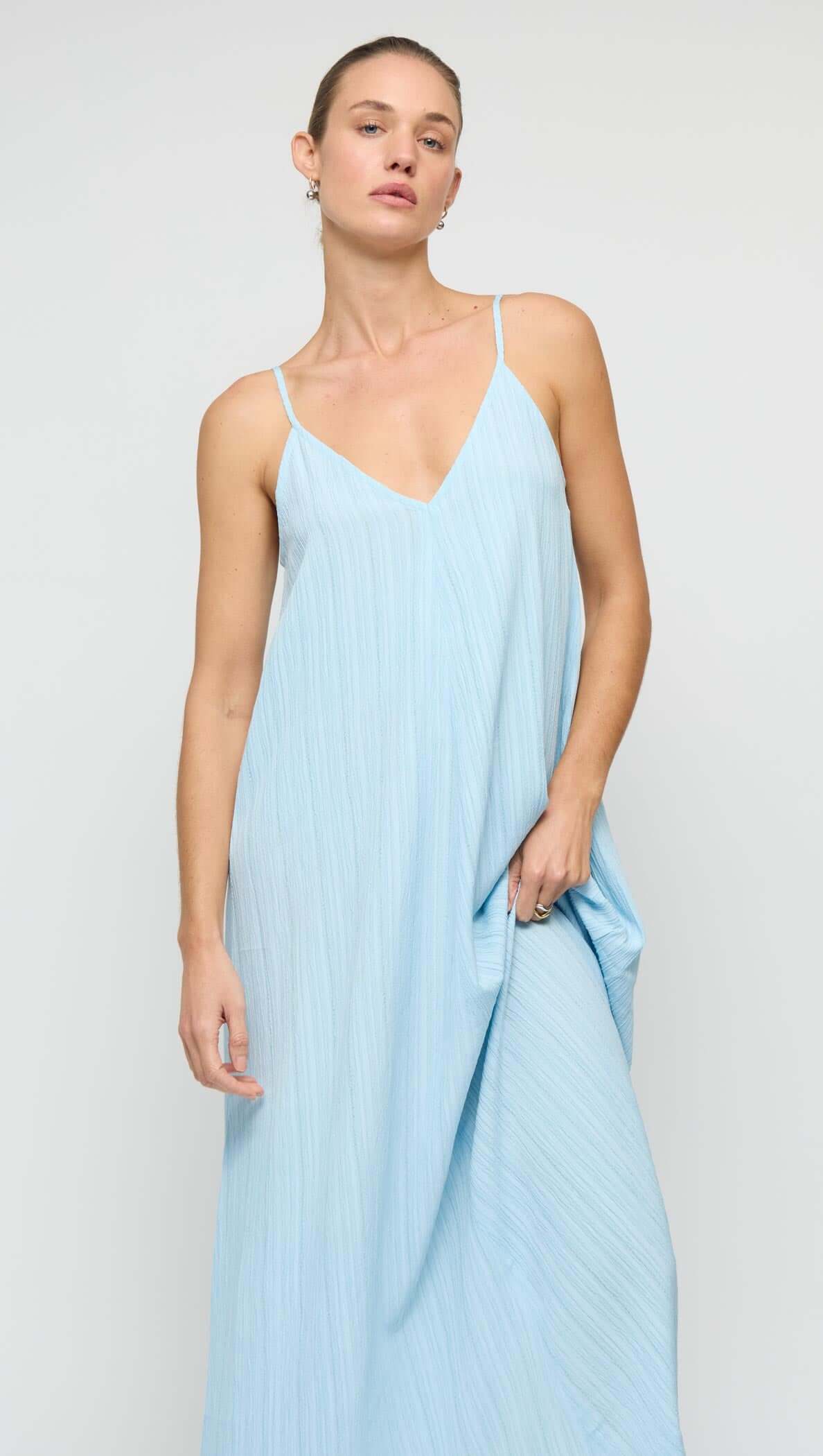 Sky Blue Crepe V-Neck Floaty Maxi Dress featuring slim adjustable straps and a flowy silhouette.