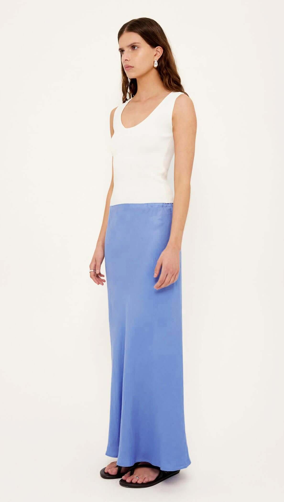 Model wearing the Jacaranda Tencel Linen Blend Maxi Skirt in cobalt, showcasing its elegant bias-cut silhouette.