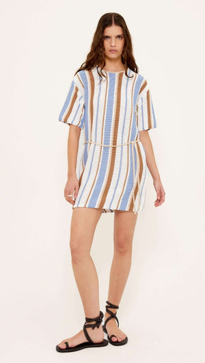 Model wearing a Striped Knit T-Shirt Mini Dress in blue, cream, and chocolate stripes with a relaxed fit.
