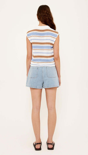 Back view of a woman wearing a Striped Knit Tank Top paired with denim shorts.