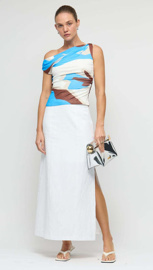 Model showcasing the Blue Abstract Asymmetric Mesh Top paired with a stylish skirt and accessories.