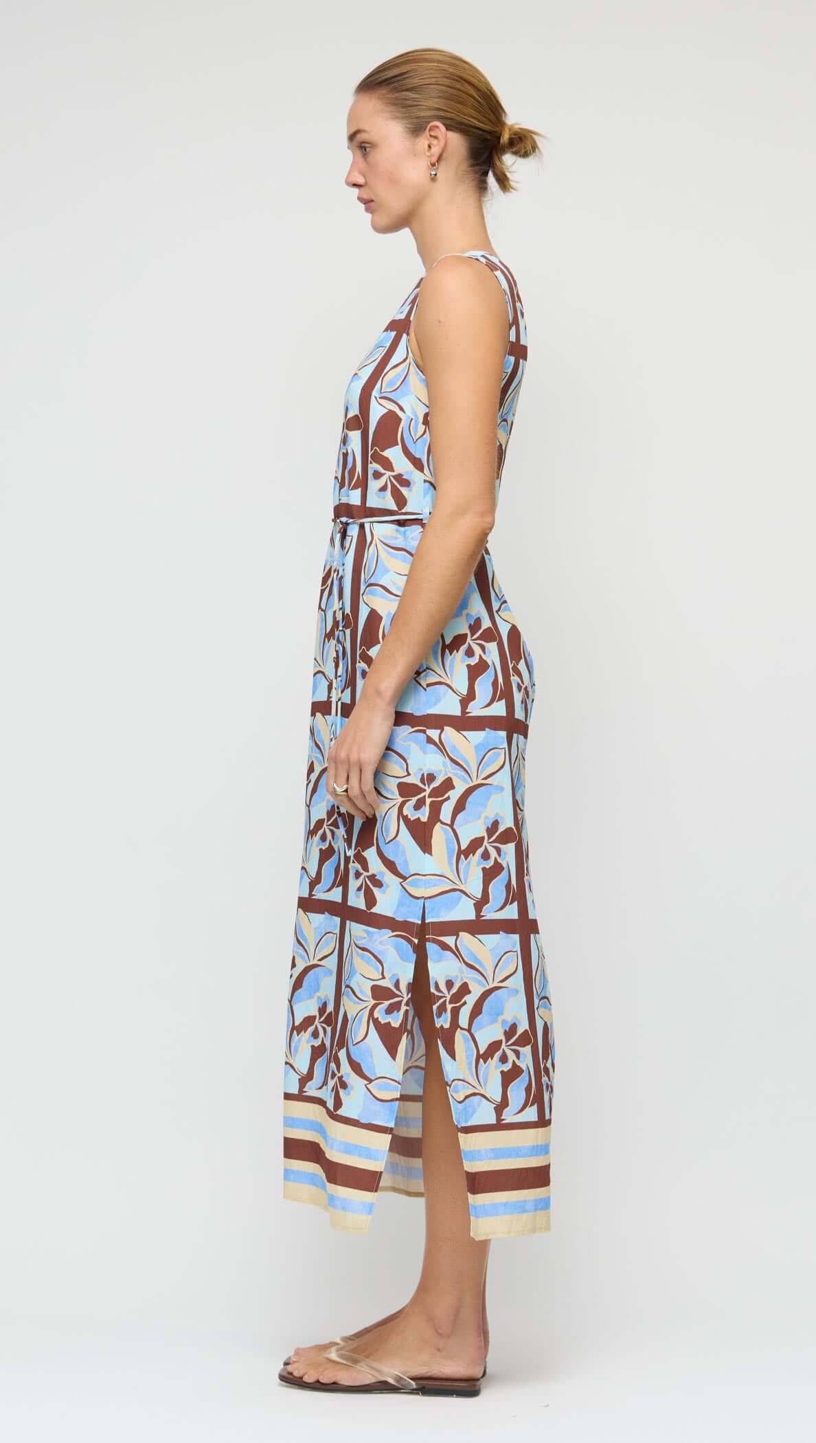 Side view of Blue Abstract floral Midi Dress with Tie Waist featuring a sleeveless design and high slit.