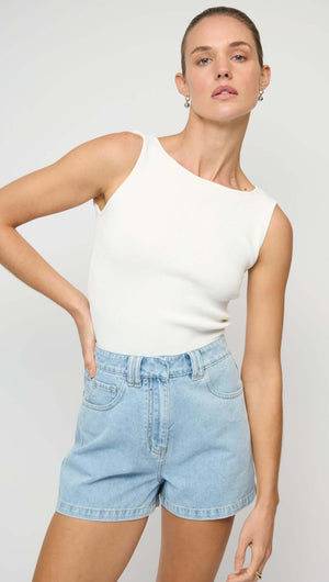 Model wearing Light Blue Denim Shorts with a white tank top, showcasing a relaxed and stylish summer outfit.