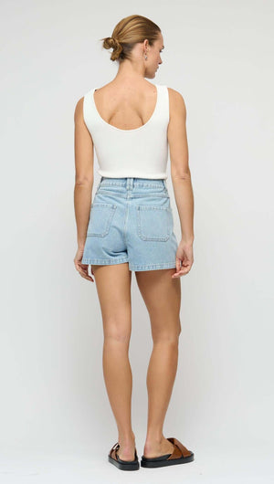 Model wearing Light Blue Denim Shorts with a white top, showcasing the back view and relaxed fit.