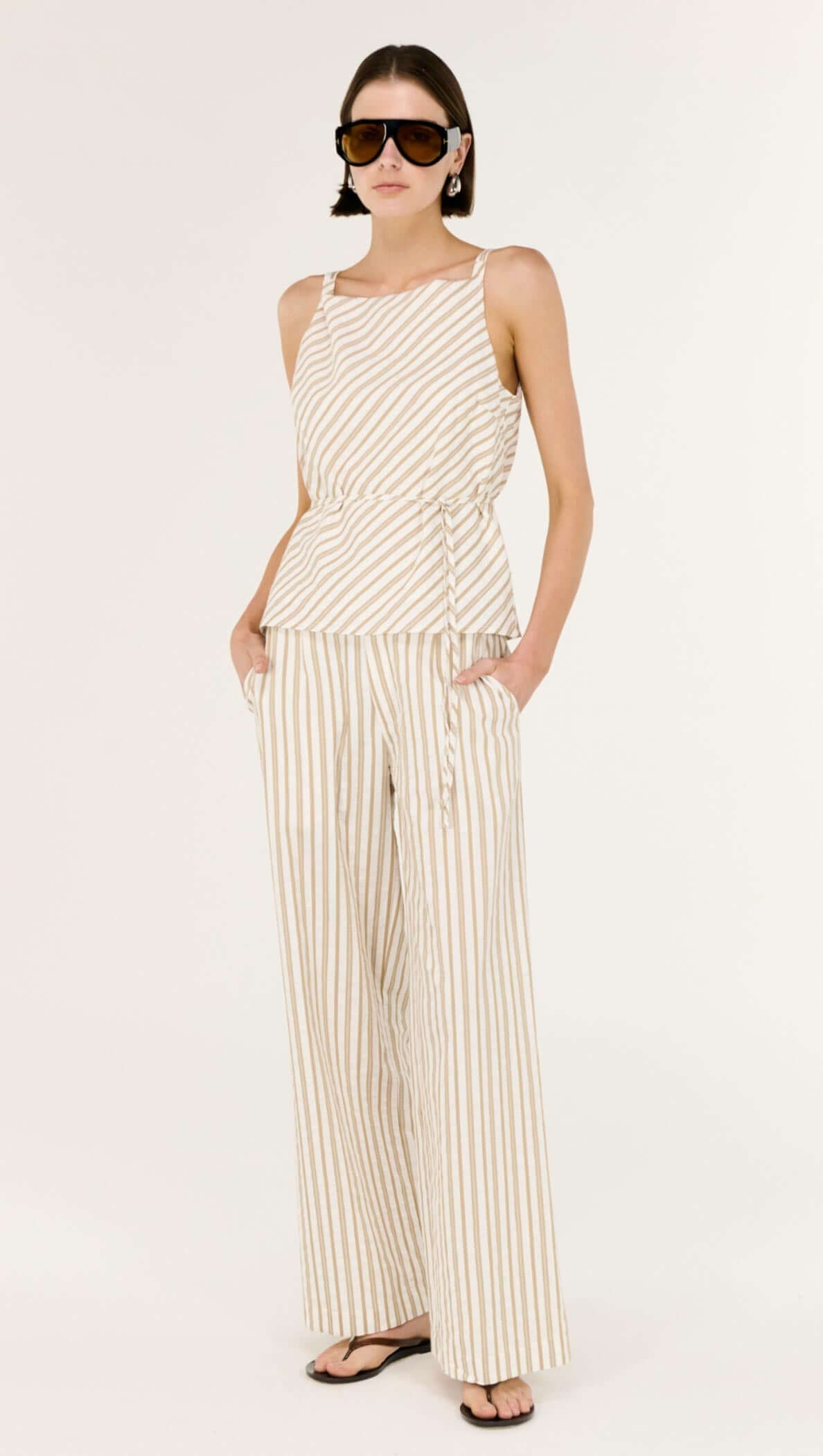 Model wearing Cotton Blend Stripe Mid-Rise Pants with a matching striped top, showcasing a relaxed, wide-leg silhouette.