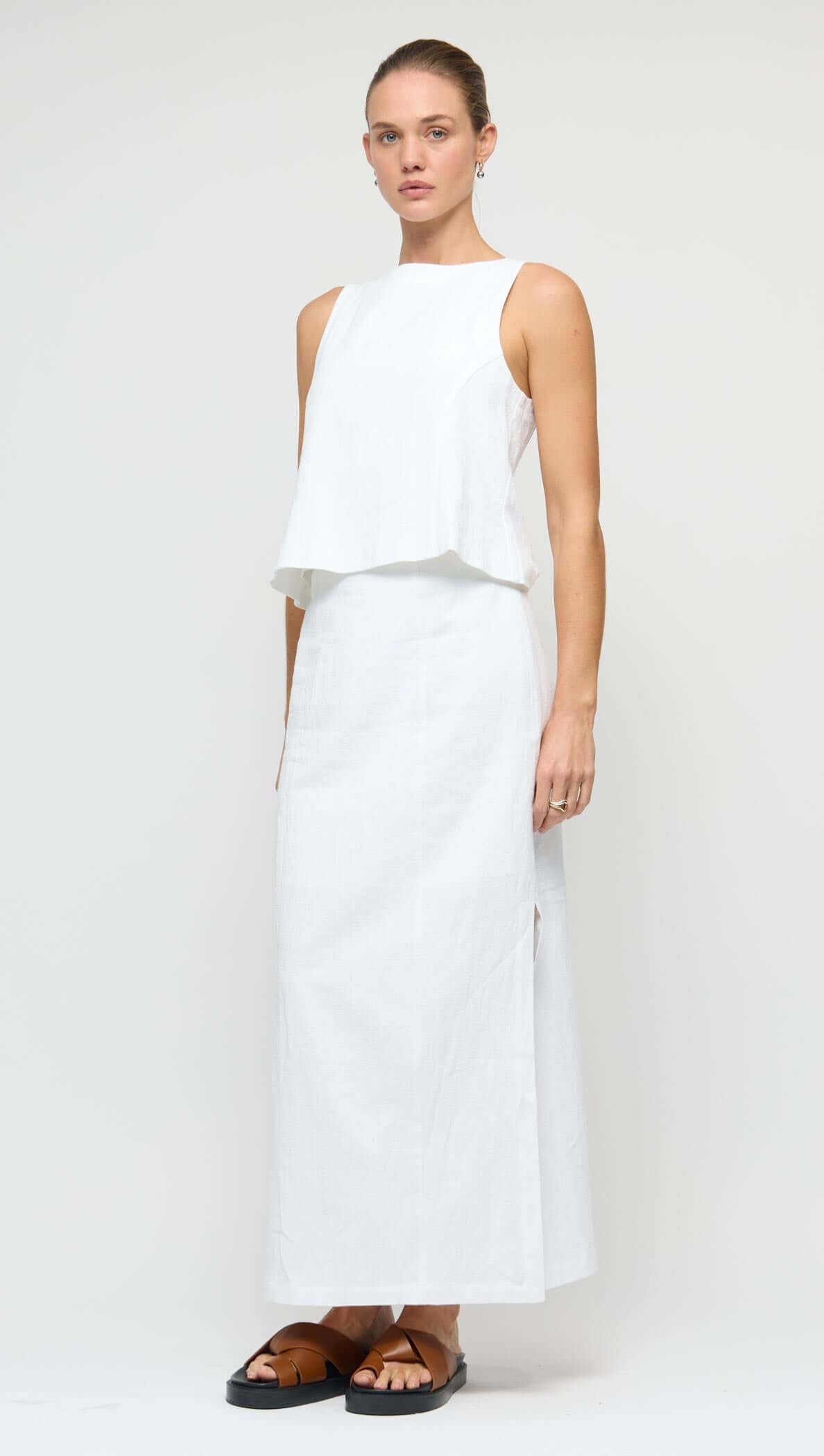 Linen Cotton Blend White Midi Skirt displayed on a model, featuring a straight silhouette and side split.