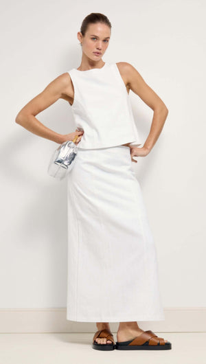 Model showcasing a stylish Linen Cotton Blend White Midi Skirt paired with a matching top and accessory.