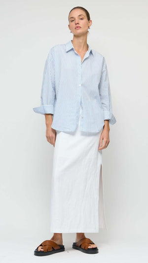 Model wearing a Linen Cotton Blend White Midi Skirt paired with a striped shirt and casual sandals.