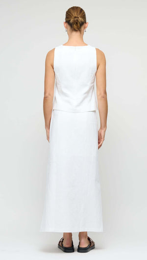 Back view of a model wearing a Linen Cotton Blend White Midi Skirt with a sleeveless top, showcasing the skirt's elegant silhouette.