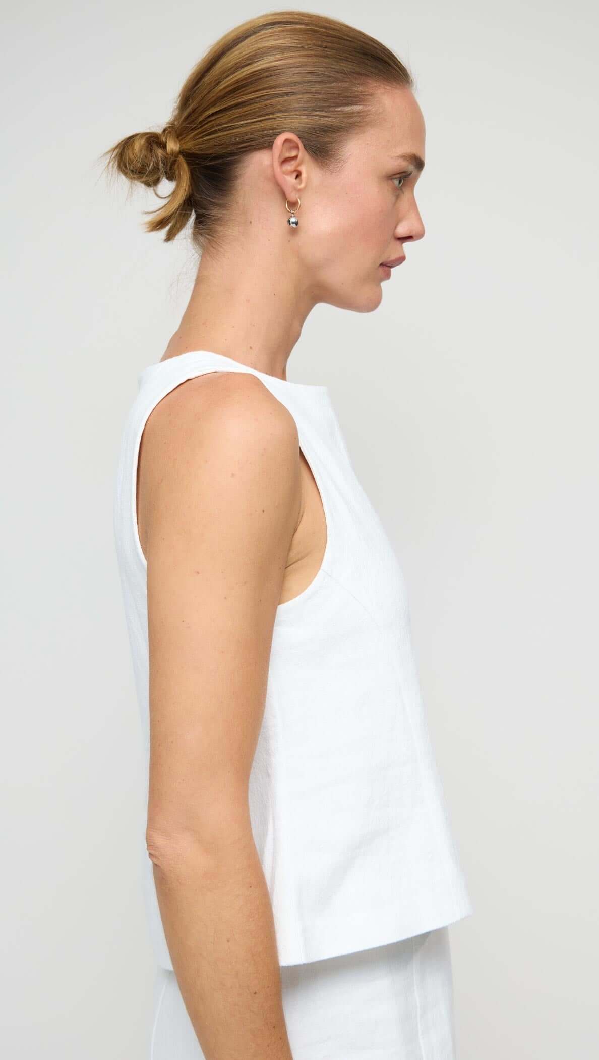 Linen Cotton Blend White Top showcased on a model, highlighting the elegant sleeveless design and structured silhouette.
