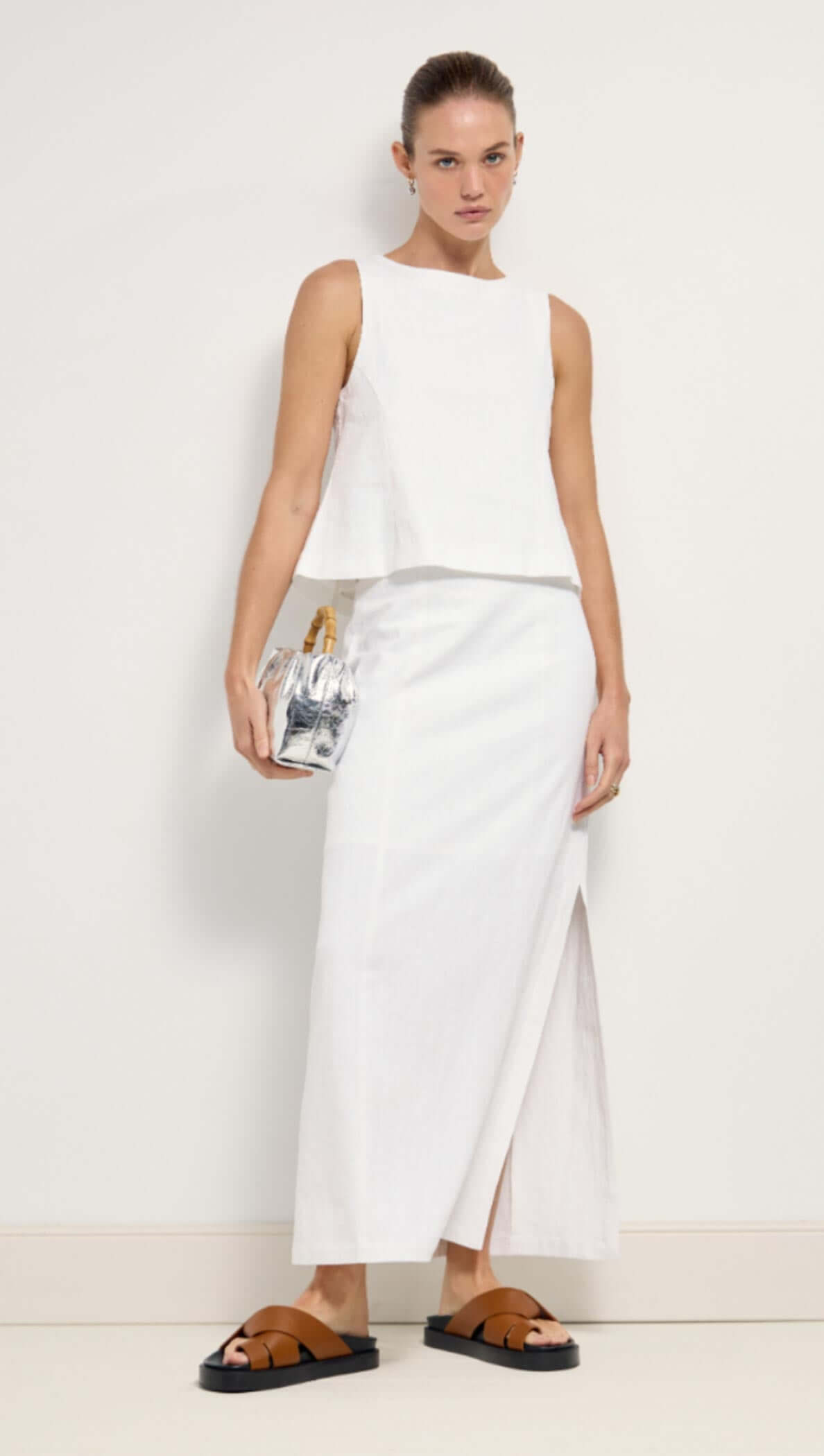 Linen Cotton Blend White Top showcased in a stylish outfit, featuring a sleeveless design and elegant silhouette.