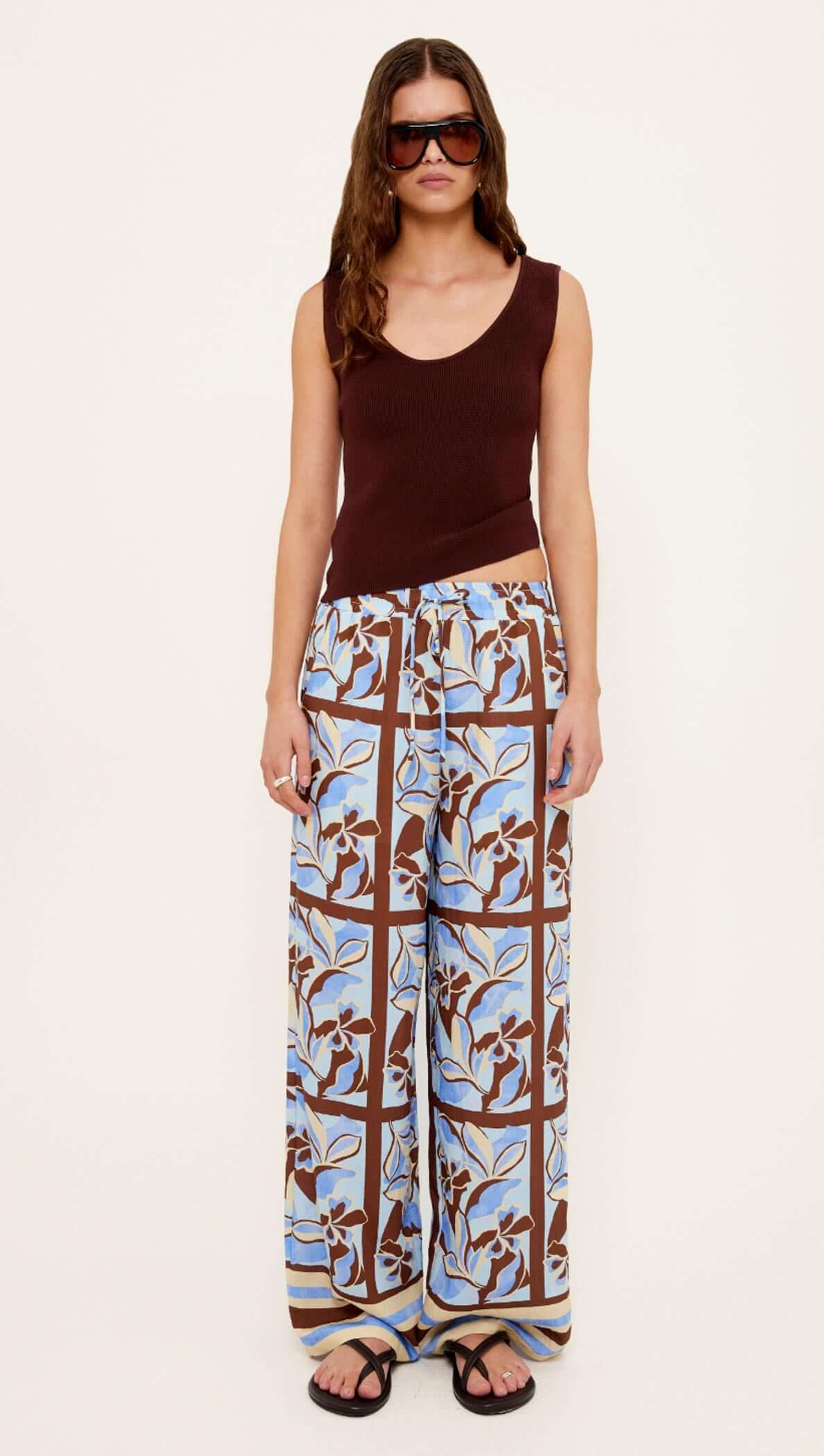 Model wearing Chocolate Brown Reversible Knit Tank Top with asymmetrical neckline and sunglasses, styled for a trendy look.