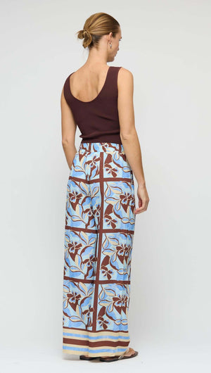 Model wearing a Chocolate Brown Reversible Knit Tank Top with patterned wide-leg pants from the back.