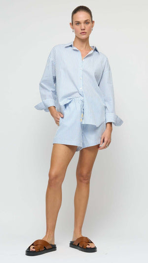 Cotton Blue & White Oversized Shirt styled with matching shorts and sandals for a relaxed summer look.