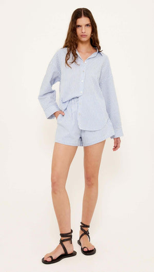 Cotton Blue & White Oversized Shirt worn with matching shorts, showcasing a relaxed and casual resort look.