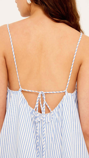 Back view of a woman wearing the Cotton Blue & White Stripe Mini Dress with adjustable tie-back straps.
