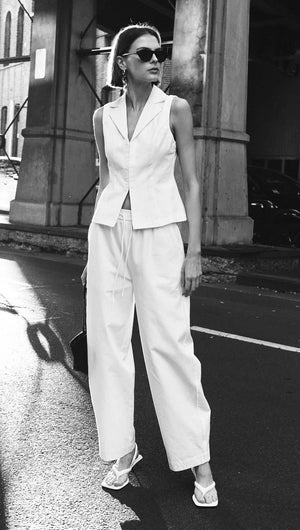Model wearing White Cotton Relaxed Wide-Leg Pant paired with a matching vest in a stylish street setting.