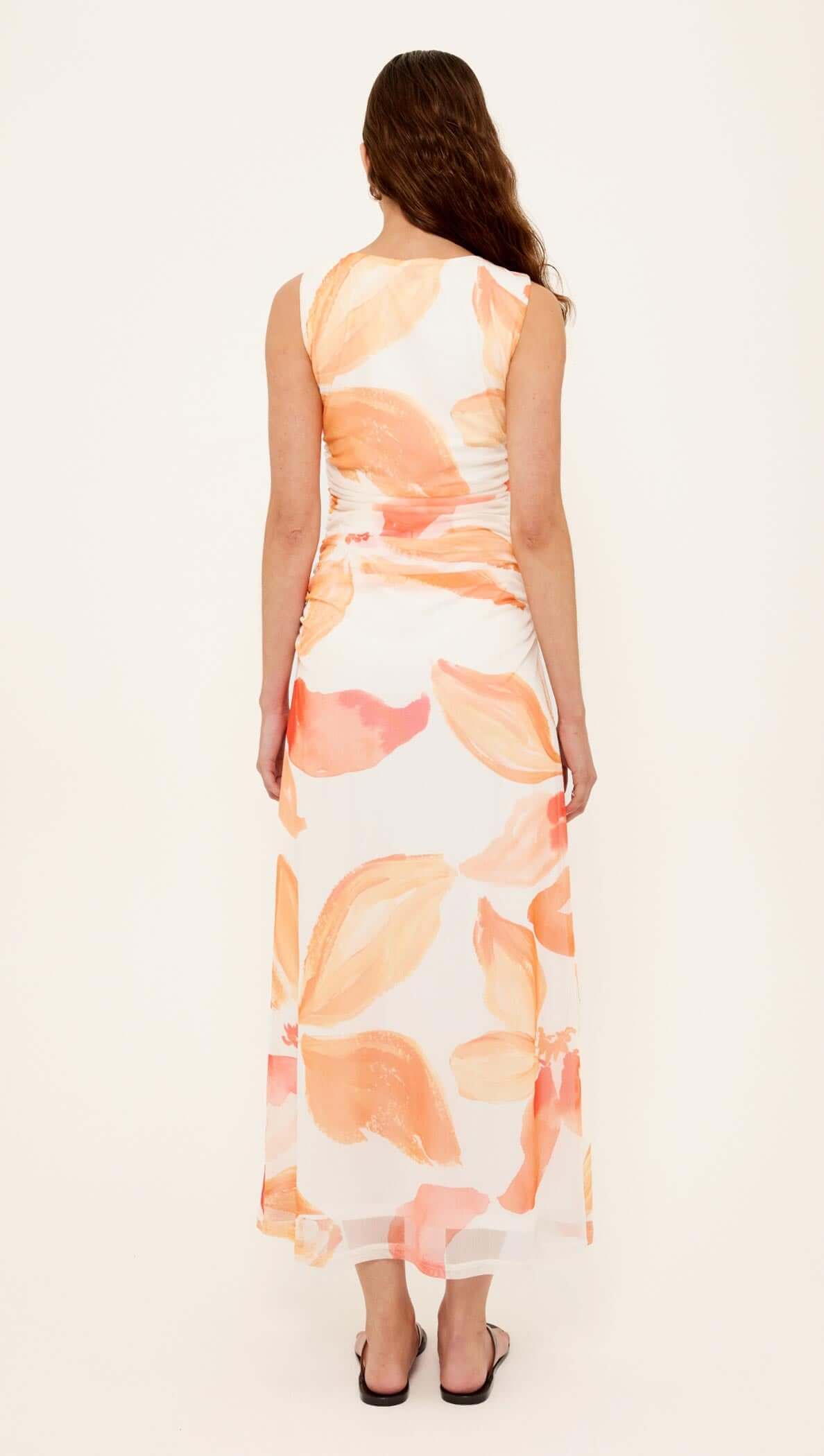 Back view of the Orange & White Floral Mesh Midi Dress showcasing its abstract floral design and flattering silhouette.