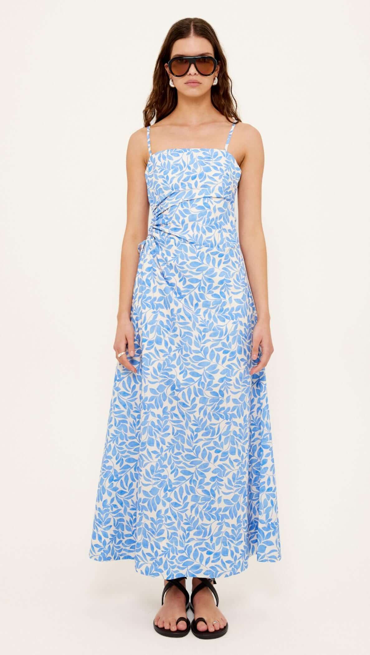 Cotton Blue Leaf Print Cut Out Maxi Dress featuring a ruched waist and side cut-out detailing, perfect for warm weather.