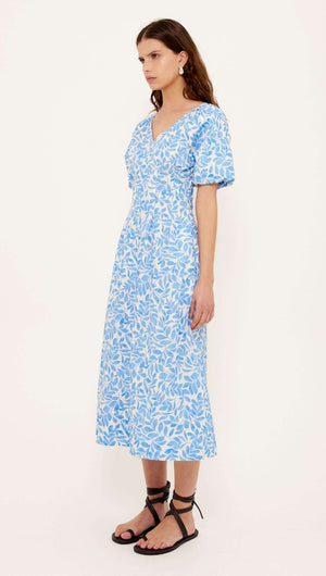Cotton Blue Leaf Print V-neck Midi Dress shown on model with short puff sleeves in blue and ivory leaf pattern.