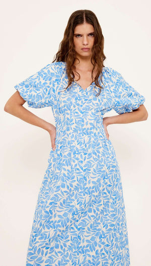 Cotton Blue Leaf Print V-neck Midi Dress featuring short puff sleeves and a soft flared skirt.