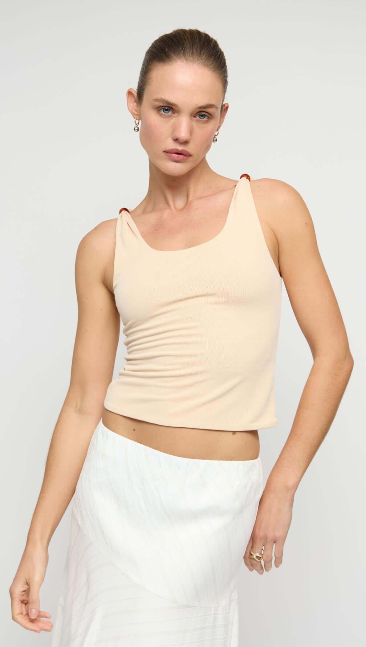 Tan Stretch Tank with Bead Detail featuring a soft ribbed knit and beaded shoulder accents on a model.