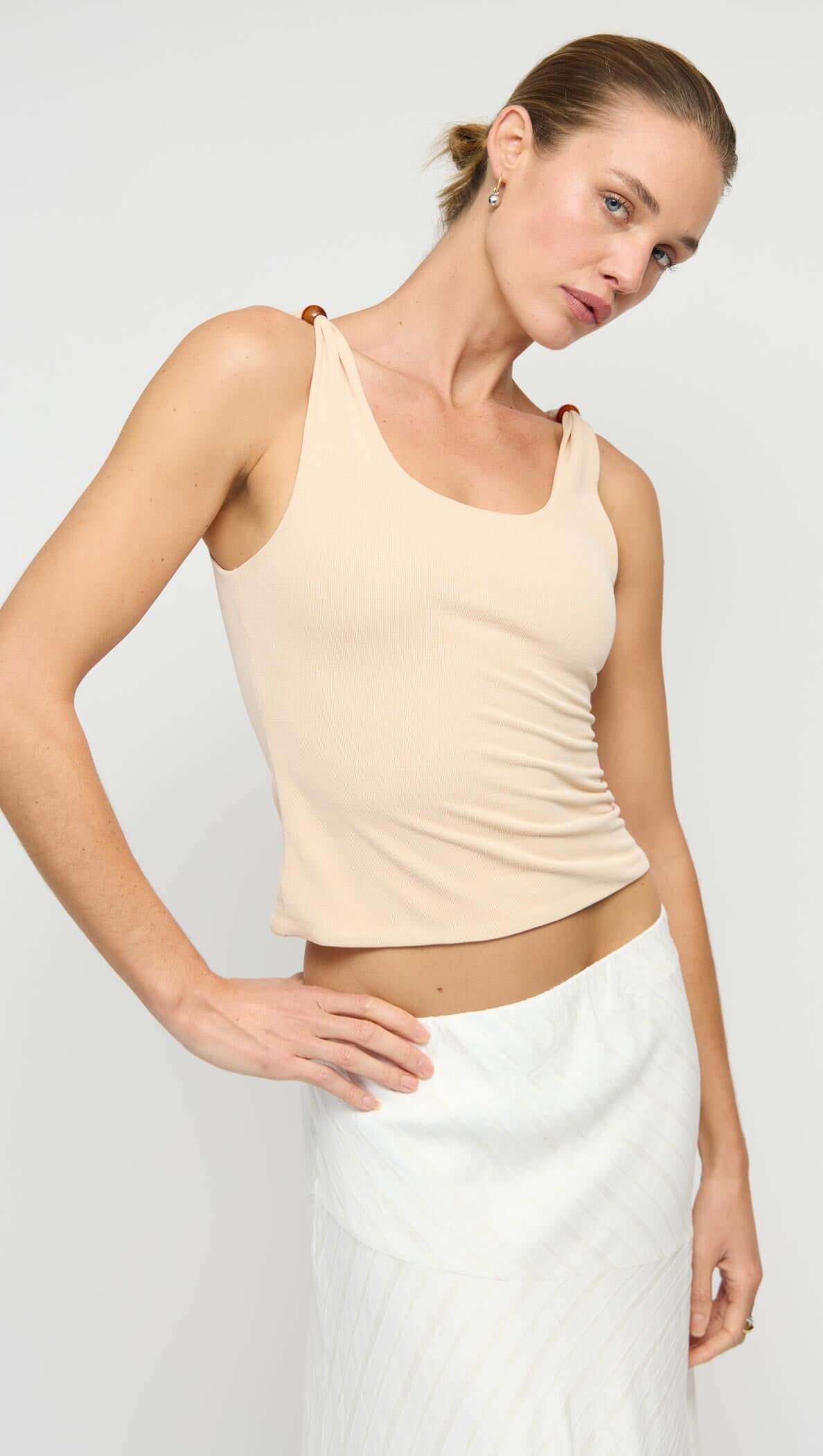 Tan Stretch Tank with Bead Detail featuring ribbed knit texture and stylish bead accents on shoulder straps.